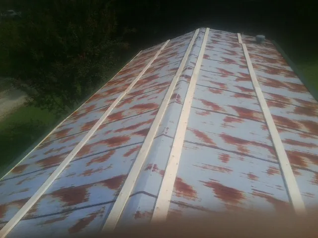 Rusted metal roof panels with new wood purlins before replacement — Storm Damage Roof Repair in Mapleton Depot by Roofing Brothers